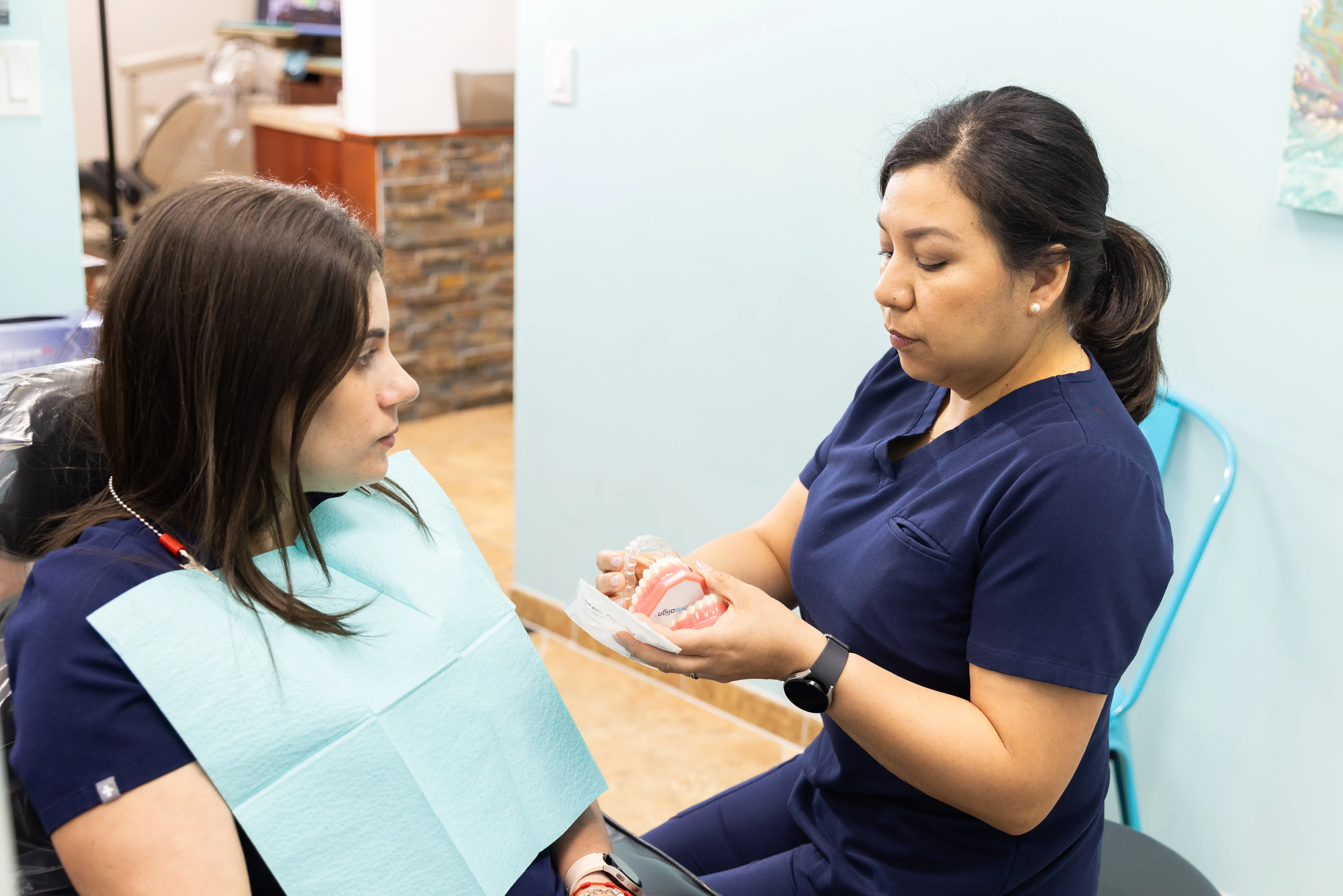 Hygienist explaining if the patient is suitable for implants