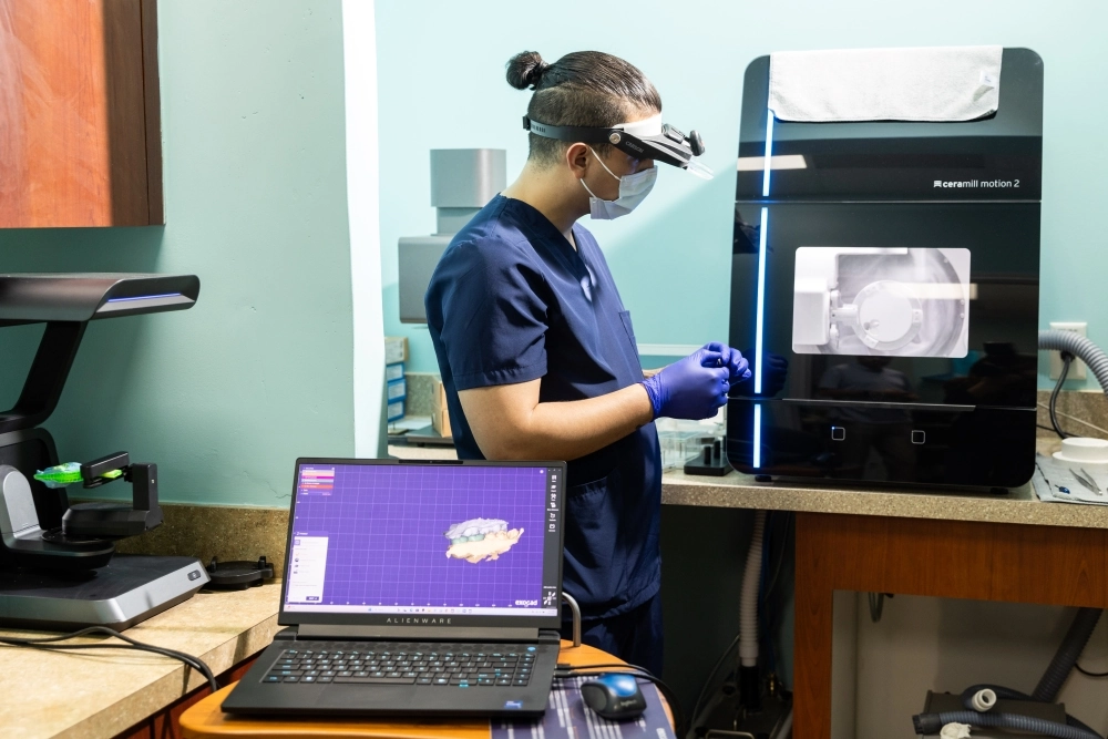 Dental technician using CAD/CAM technology